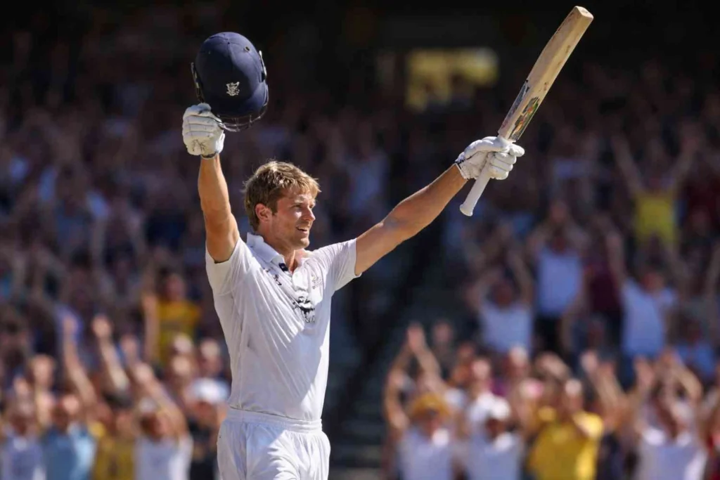 England’s Jacob Bethell celebrates his maiden Test and first-class century on Day 4 of the 5th Ashes Test against Australia at the SCG, raising his bat and helmet to a cheering crowd.